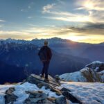 man hiking in snowy mountains at sunset online porn recovery program