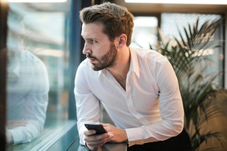 Man sitting alone on his phone How much porn is an addiction